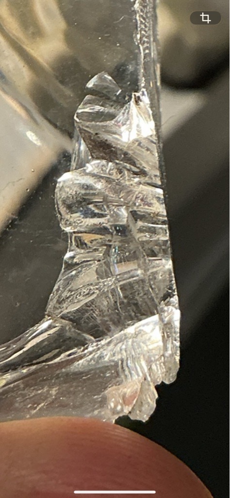 Not a diamond; this appears to be broken or fractured glass or quartz material. - Irregular / Raw fragment