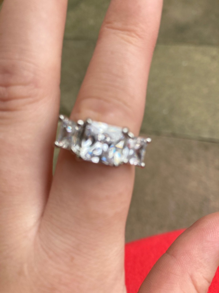 Natural Diamond (estimated based on classic multi-stone luxury setting) - Radiant Cut (center stone) with Baguette or Trapezoid side stones