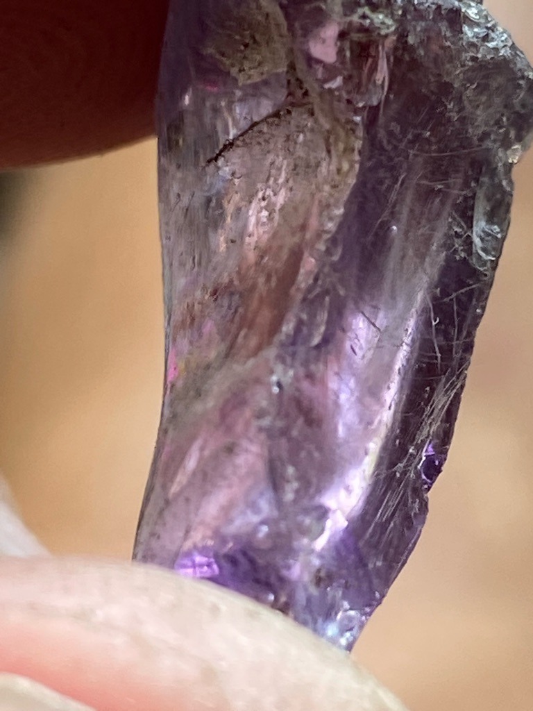 Not a diamond; appears to be a raw, unpolished crystal of purple quartz (amethyst) or potentially another purple gemstone like spinel or sapphire in a rough state. - Rough crystal, uncut and unshaped natural form.