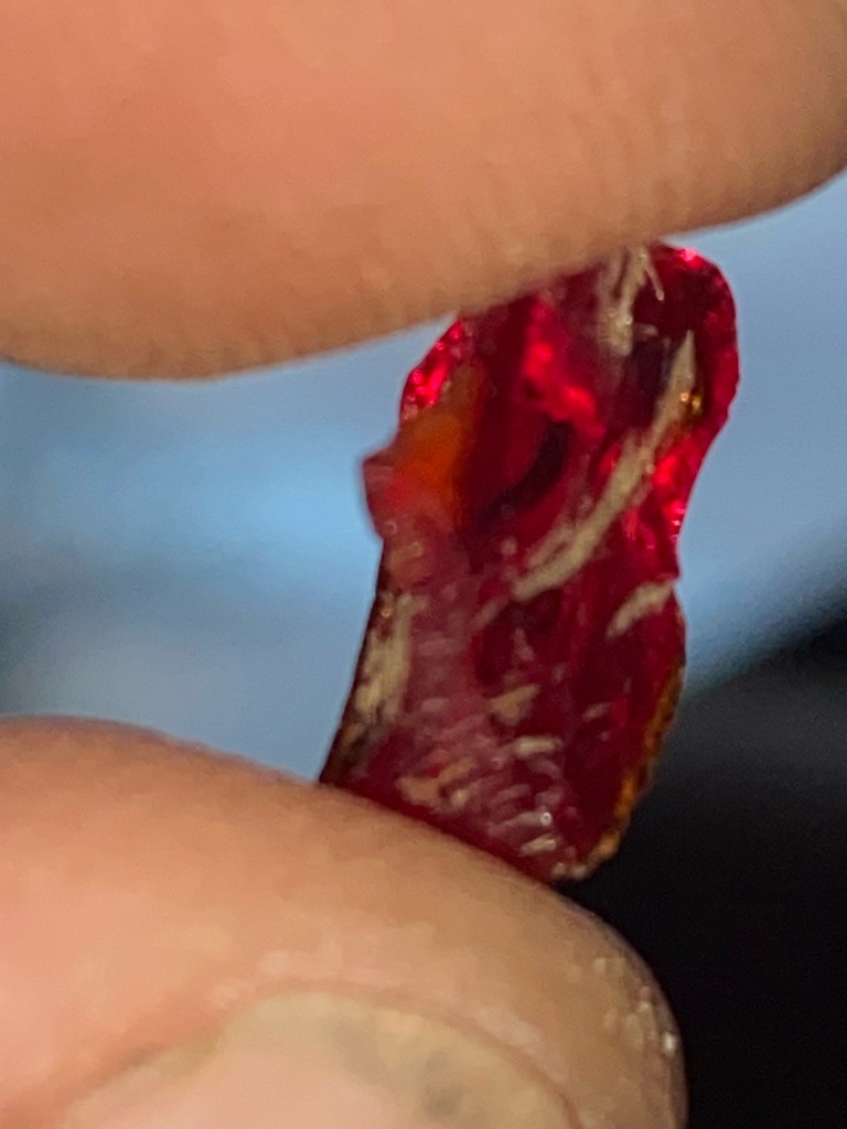 The specimen shown in the image is not a diamond; it appears to be a natural rough red gem-grade mineral, likely ruby or spinel. - Rough crystal formation, unpolished and uncut