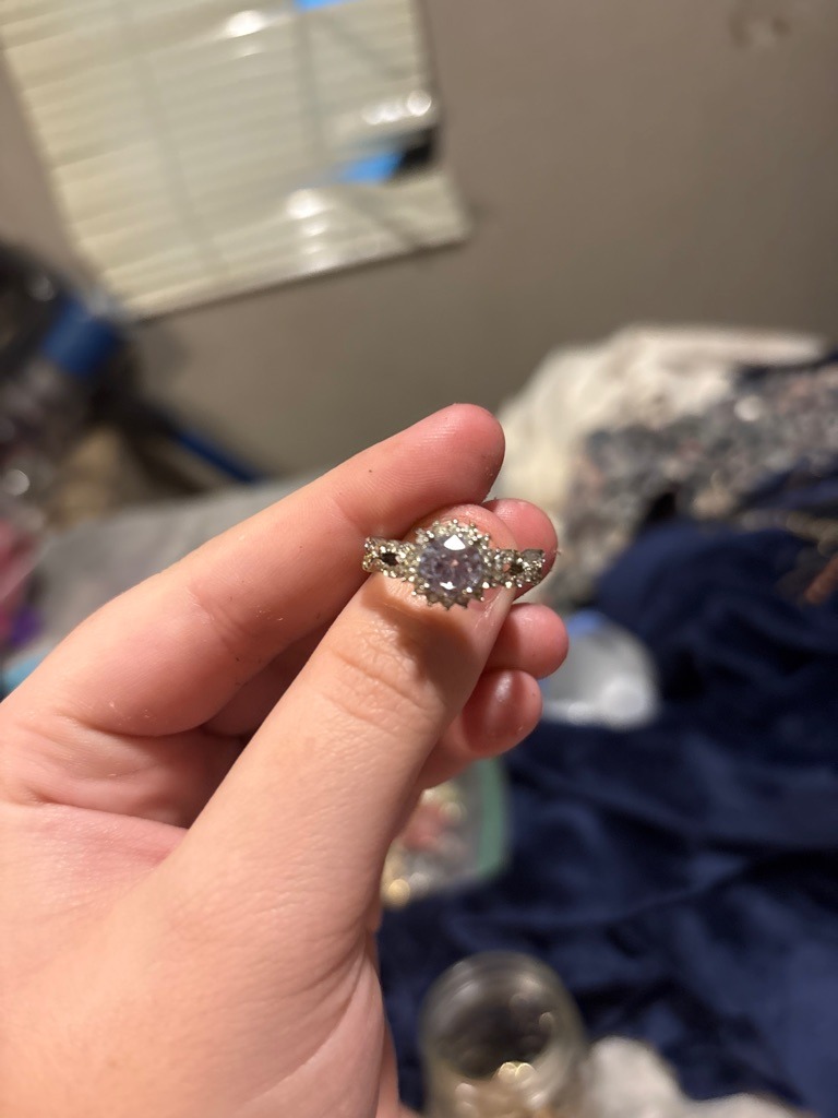 Natural Diamond (Assumed based on typical halo ring settings, though lab-grown cannot be ruled out without advanced testing) - Round Brilliant