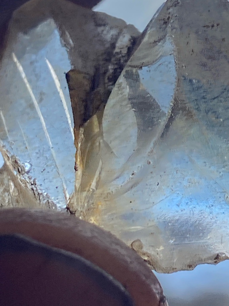 Not a diamond; appears to be raw quartz crystal or fractured mineral specimen, possibly glass or quartz shard showing conchoidal fracture patterns. - Irregular raw crystal shard / Uncut fragment