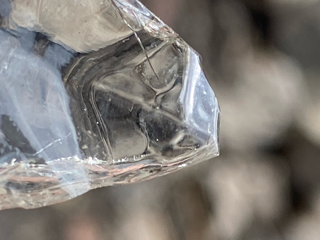 Not a diamond; appears to be quartz, glass, or another transparent crystalline mineral / raw crystal fragment. - Raw, uncut, or irregularly fractured crystalline fragment.
