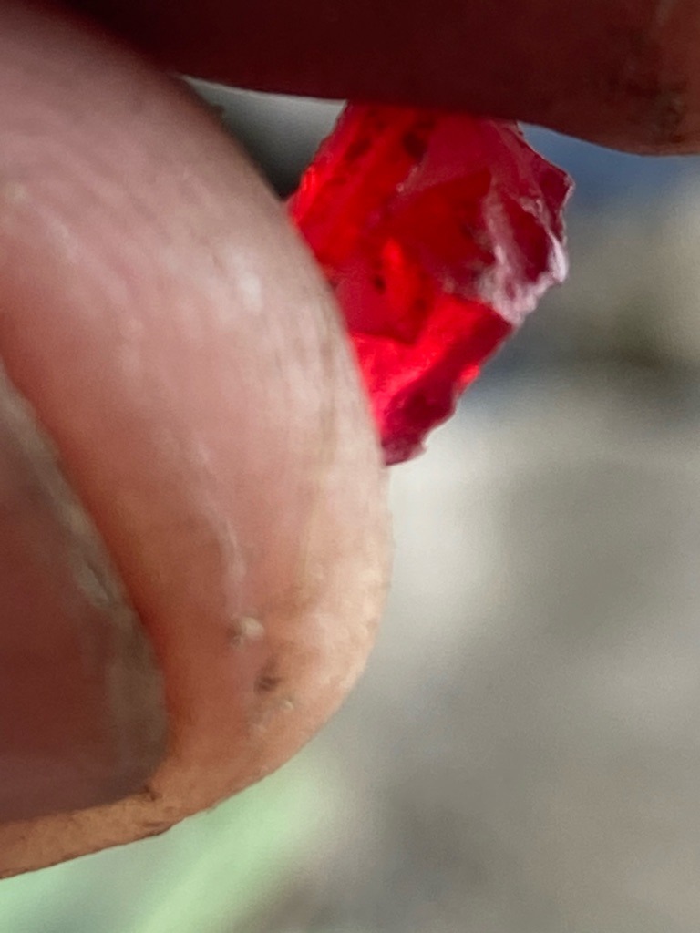 Not a diamond; appears to be a natural red rough gemstone such as ruby or spinel, though verification requires specialized gemological testing. - Rough crystal / Raw uncut form