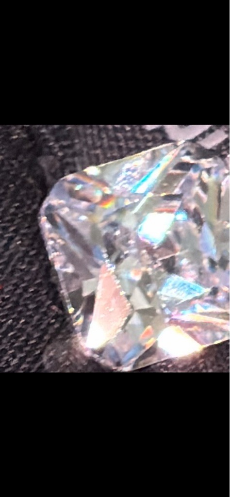 Likely Diamond Simulant (e.g., Cubic Zirconia or Moissanite) - Emerald or Radiant Cut (Rectangular Step/Mixed)