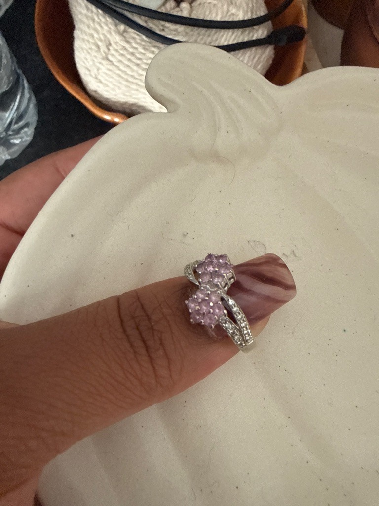 The main colored stones appear to be pink sapphires or tourmalines arranged in cluster settings, accompanied by small accent diamonds along the shank. - Round Brilliant (for the accent stones and cluster components)