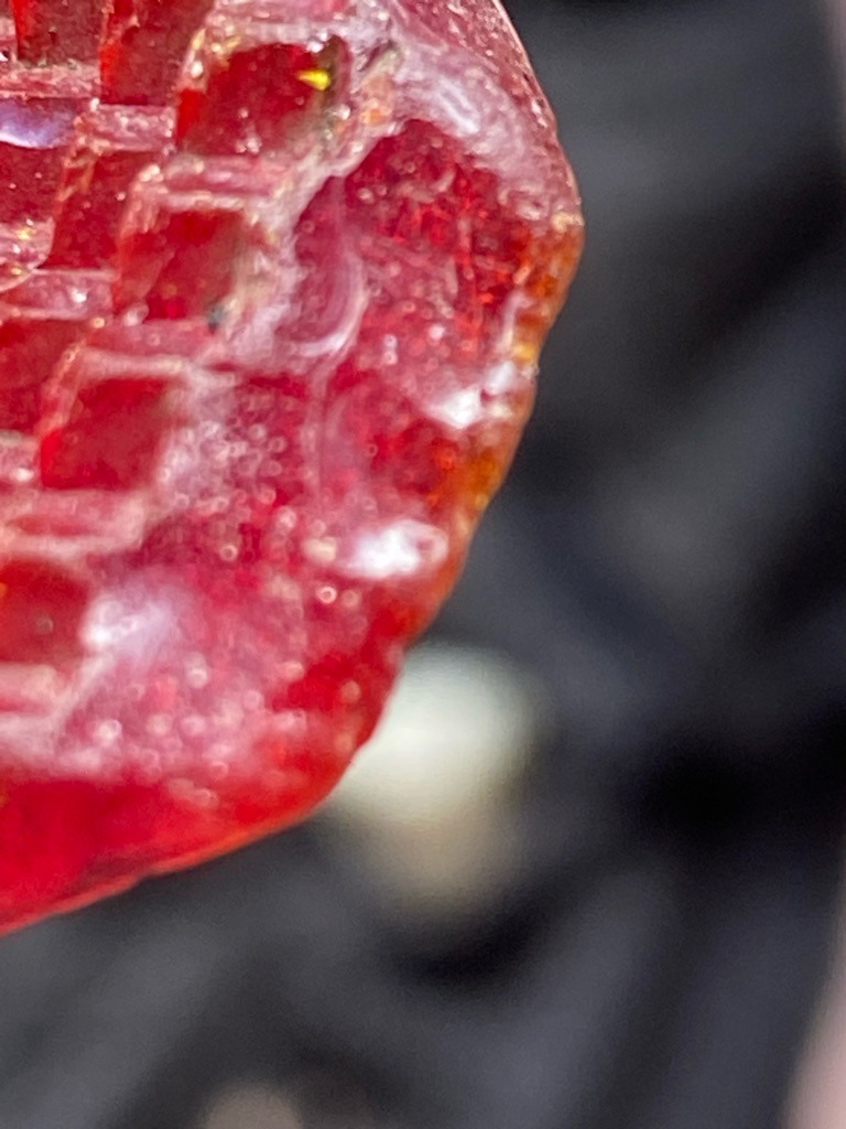 Not a diamond; this is a rough mineral crystal, likely a red colored mineral specimen such as vanadinite, cinnabar, or rubellite tourmaline rather than a diamond. - Rough crystal habit with natural crystal faces and step-like growth structures (not a standard faceted cut shape).