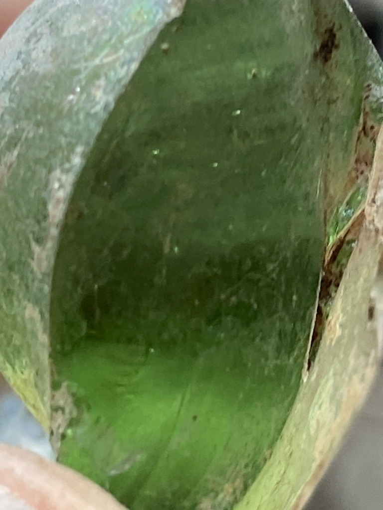 Not a diamond; appears to be raw green glass or slag, possibly historical bottle glass. - Irregular raw fragment / unstructured sherd