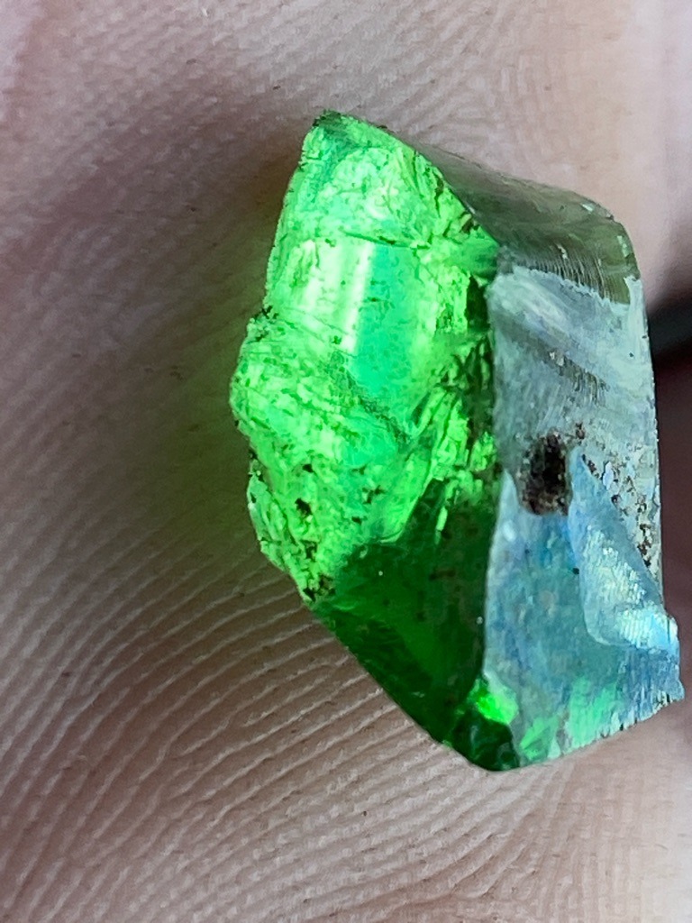 Not a diamond; this specimen appears to be a natural green gemstone, likely emerald, green tourmaline, or green glass/synthetic material given the vivid green color and raw crystal morphology. - Rough crystal / Uncut fragment