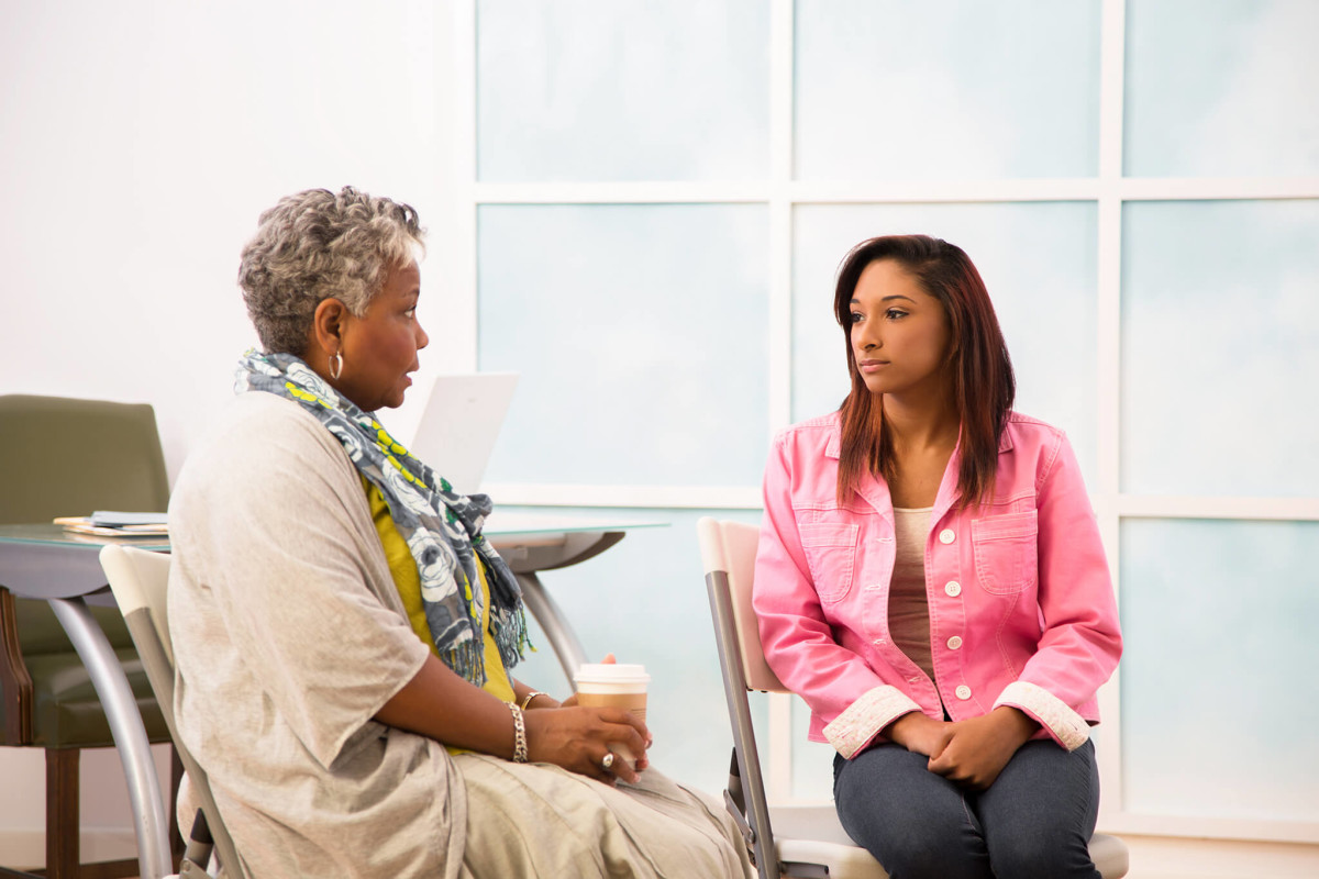 counselor talks to woman in office