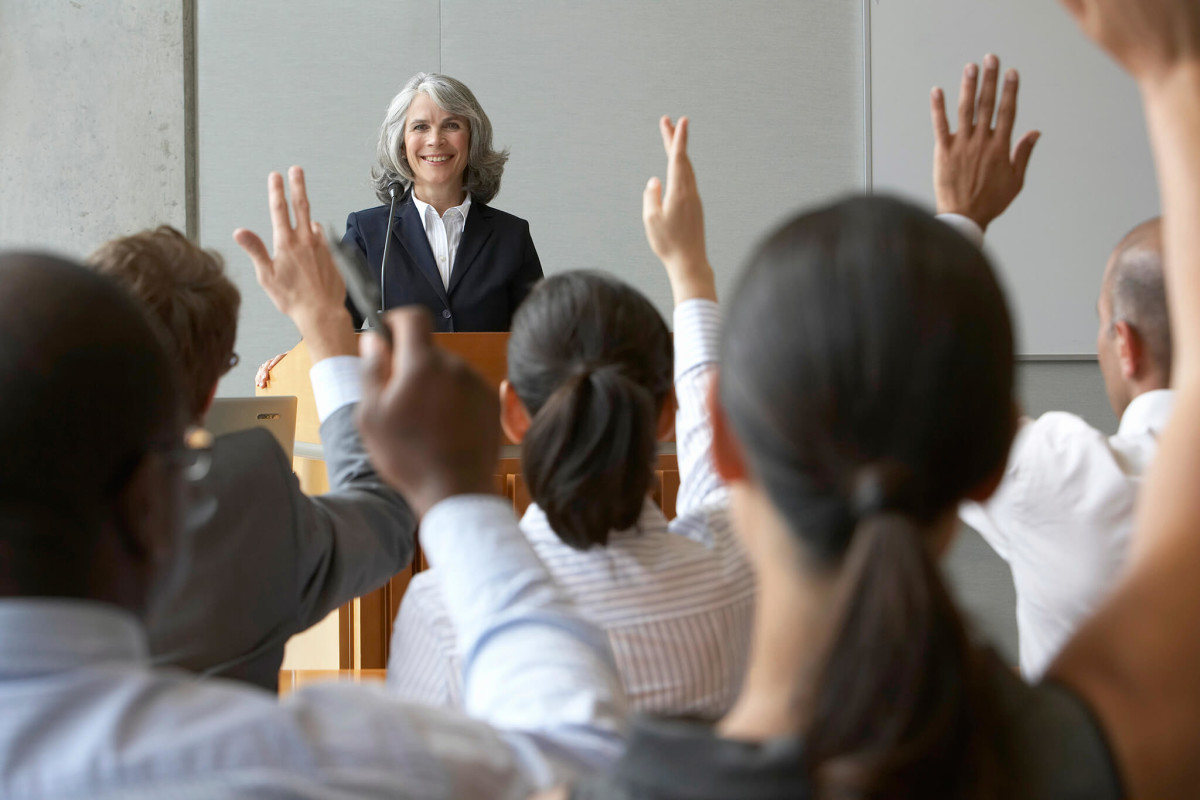 Business woman at podium-presenting at conference