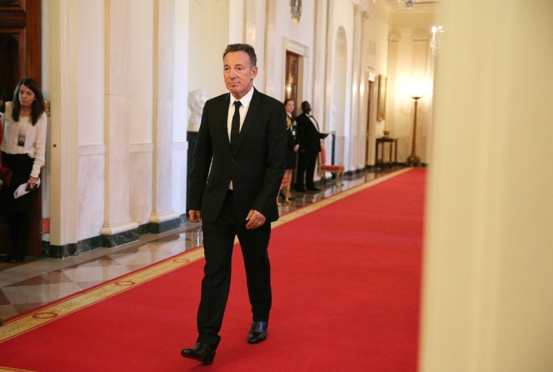 Musician Bruce Springsteen walks to his seat before a ceremony awarding the Presidential Medal of Freedom to various receipients in the East