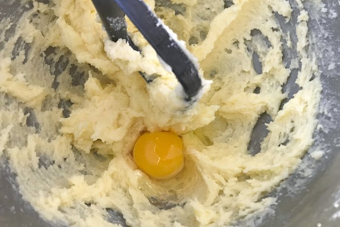 Egg being incorporated into butter/sugar mixture during creaming method