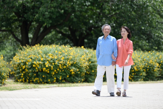 腕を組んで歩く中年男女