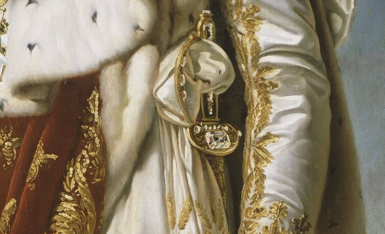 a close up of a sword on a decorative robe in a portrait