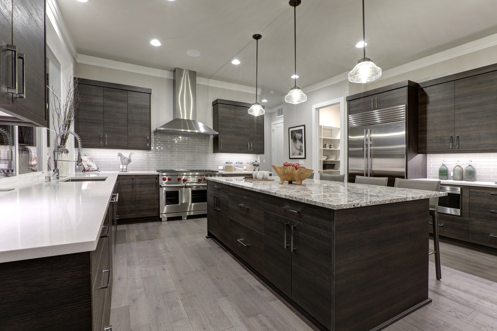 Modern gray kitchen features dark gray flat front cabinets paired with white quartz countertops and glossy gray linear tile backsplash