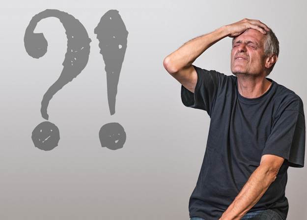 A man has his hand on his head in a gesture of painful realization