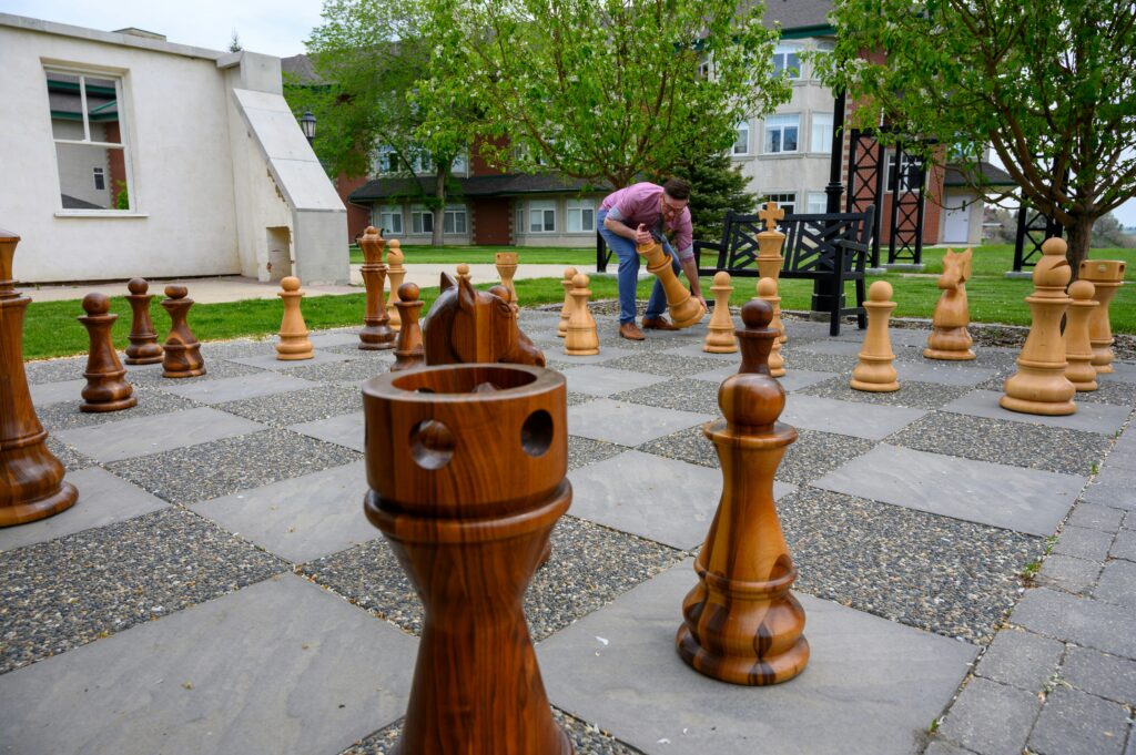 A giant chess set in a park.