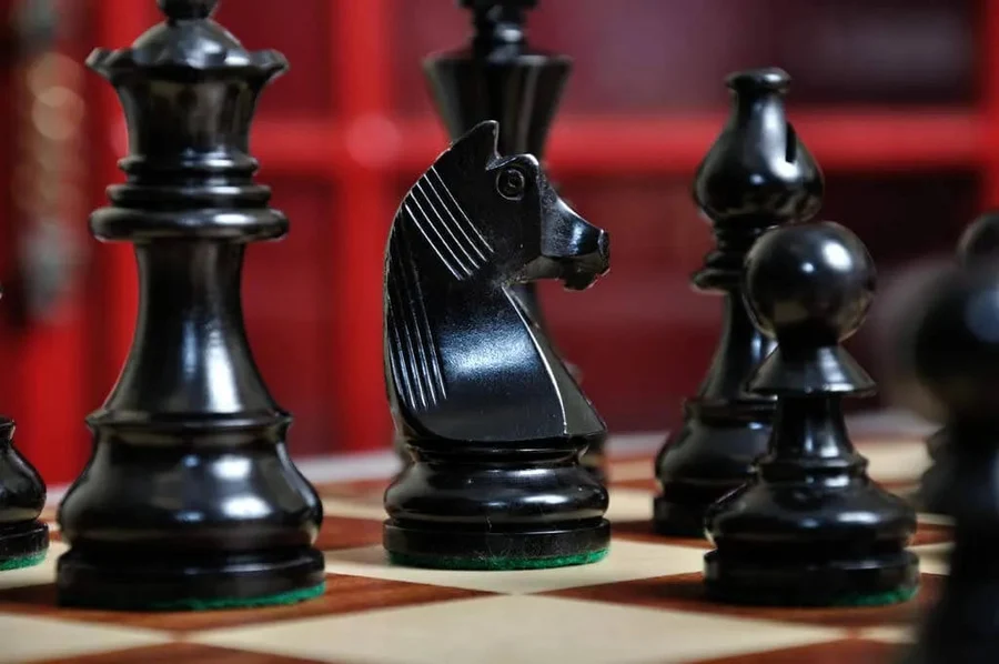 Chess pieces with a shiny finish in close up.