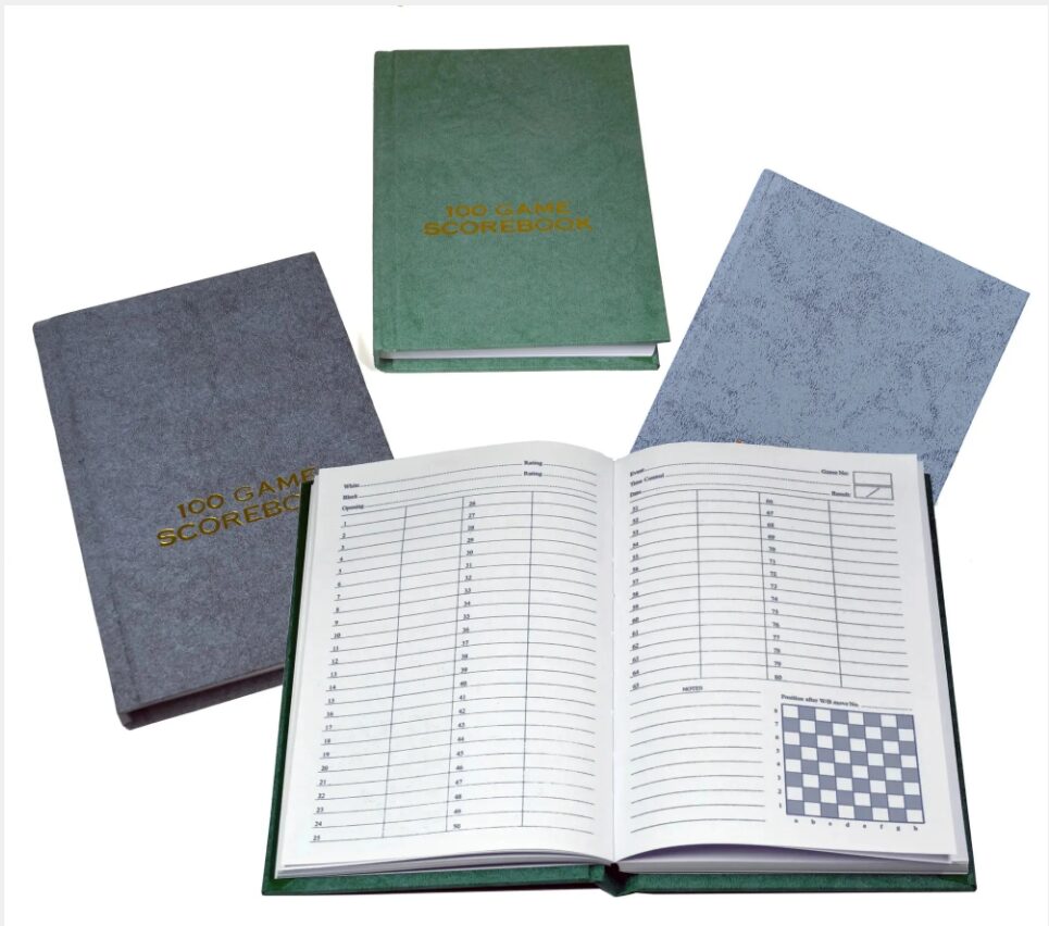 Four scorebooks in various colors are displayed with one open to a blank score sheet.