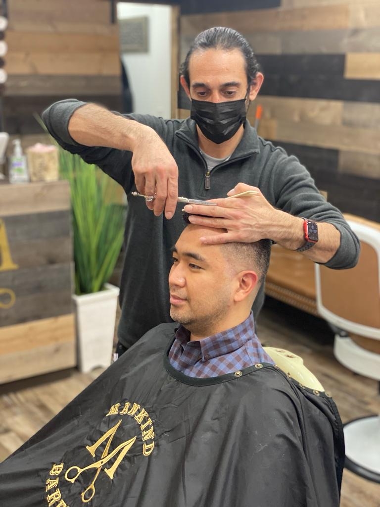 What are some advanced men's barbering techniques for creating intricate designs and patterns in hair?