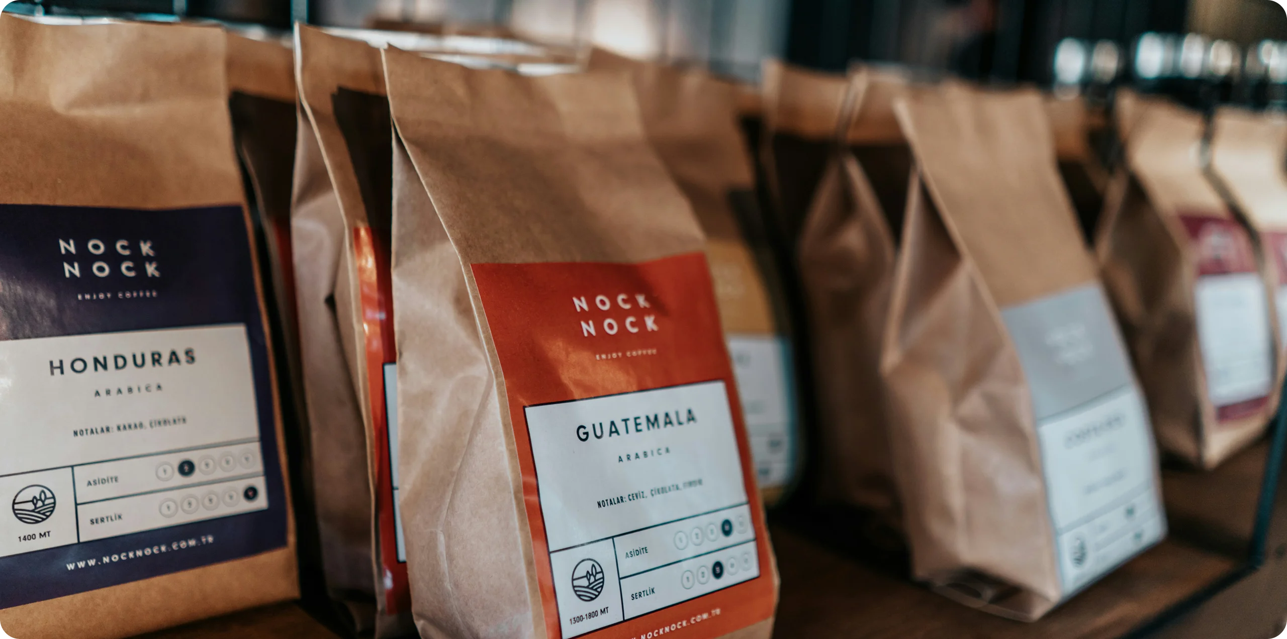 Coffee bags lined up on a shelf