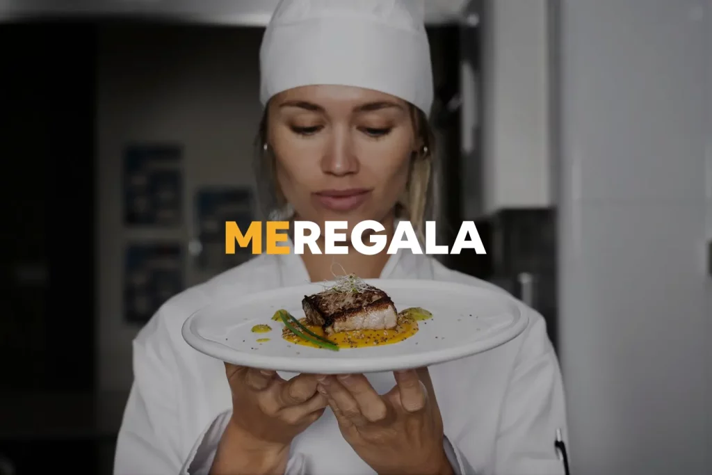 Female chef in the kitchen holding plate of steak