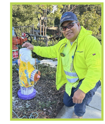 MPWD Water Operator poses with a Belmont Happy Hydrant in the community.