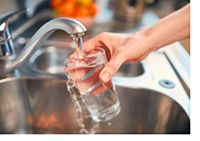 water quality image of water glass being filled by kitchen faucet