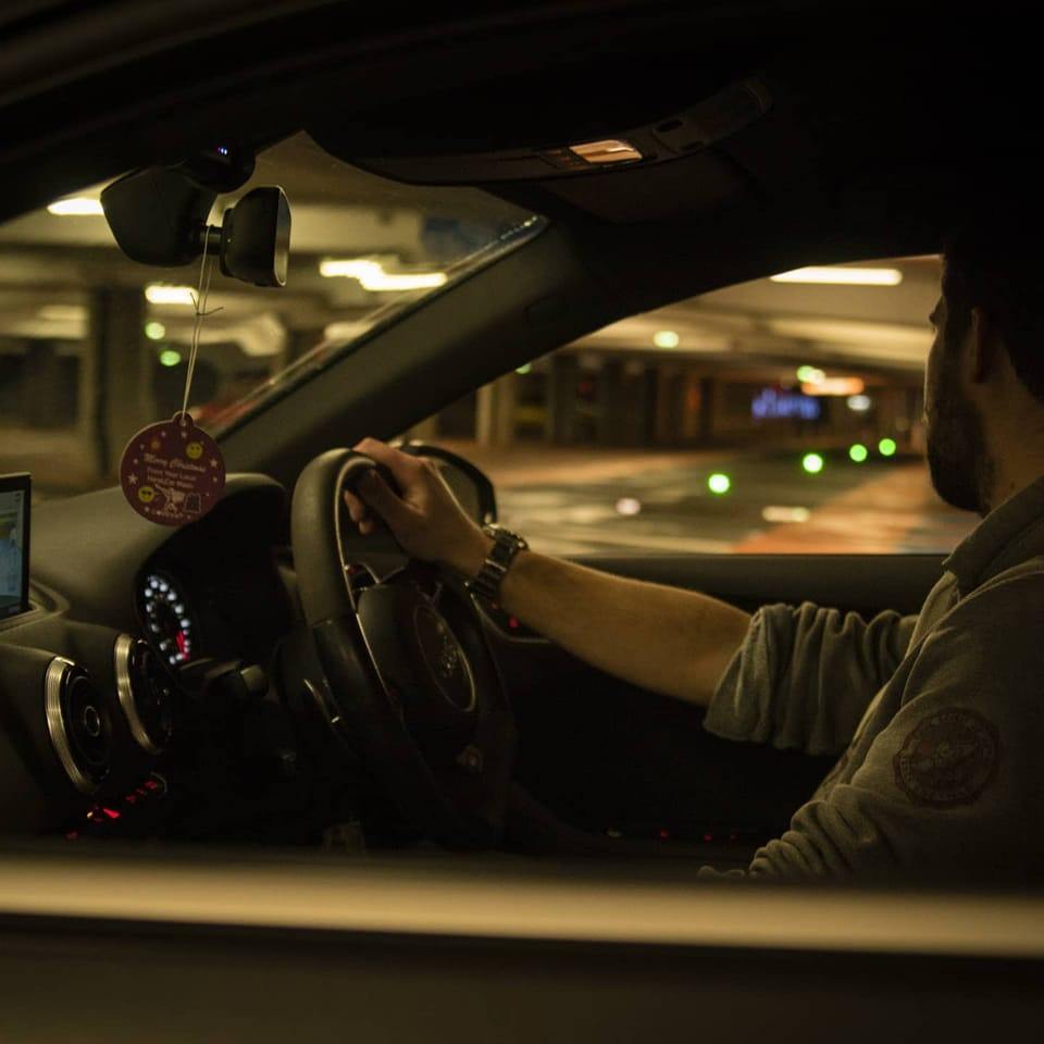 A profile image of Andrew Townsend, an infrastructure engineer for software engineering company Mindera, driving his car in a car park. 