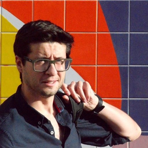 Aires Oliveira is a man wearing glasses, a t-shirt, and a watch. Aires Oliveira is a man wearing glasses, a t-shirt, and a watch.