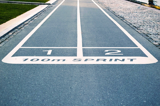 A running track with two lanes (one and two) and text that says “100m SPRINT”.