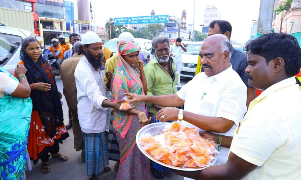 sanitation worker taking away the shoes of kumaragurubaran