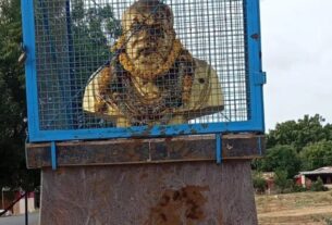 Throwing cow dung on the statue of Periyar