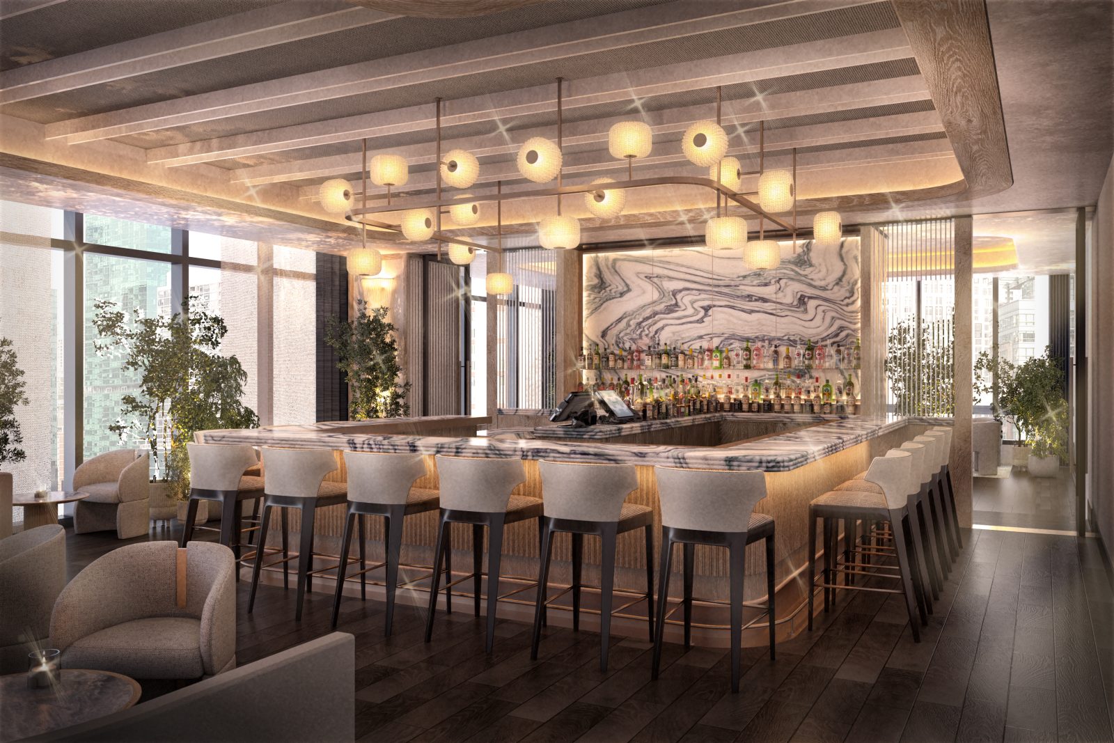 The bar at Miru with cream stools, marble top and an expansive light fixture.