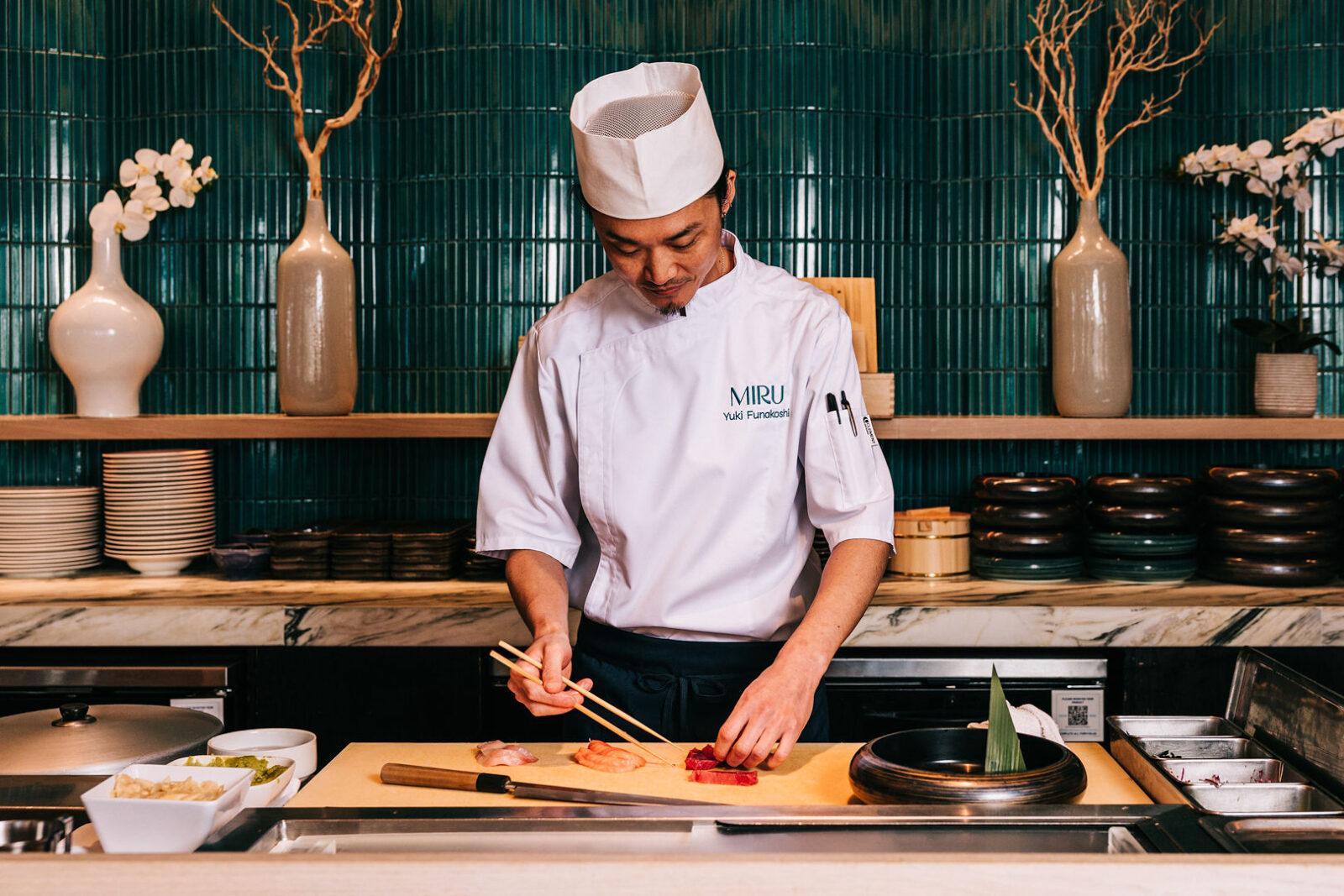 Sushi Chef preparing akami sashimi behind the sushi bar.