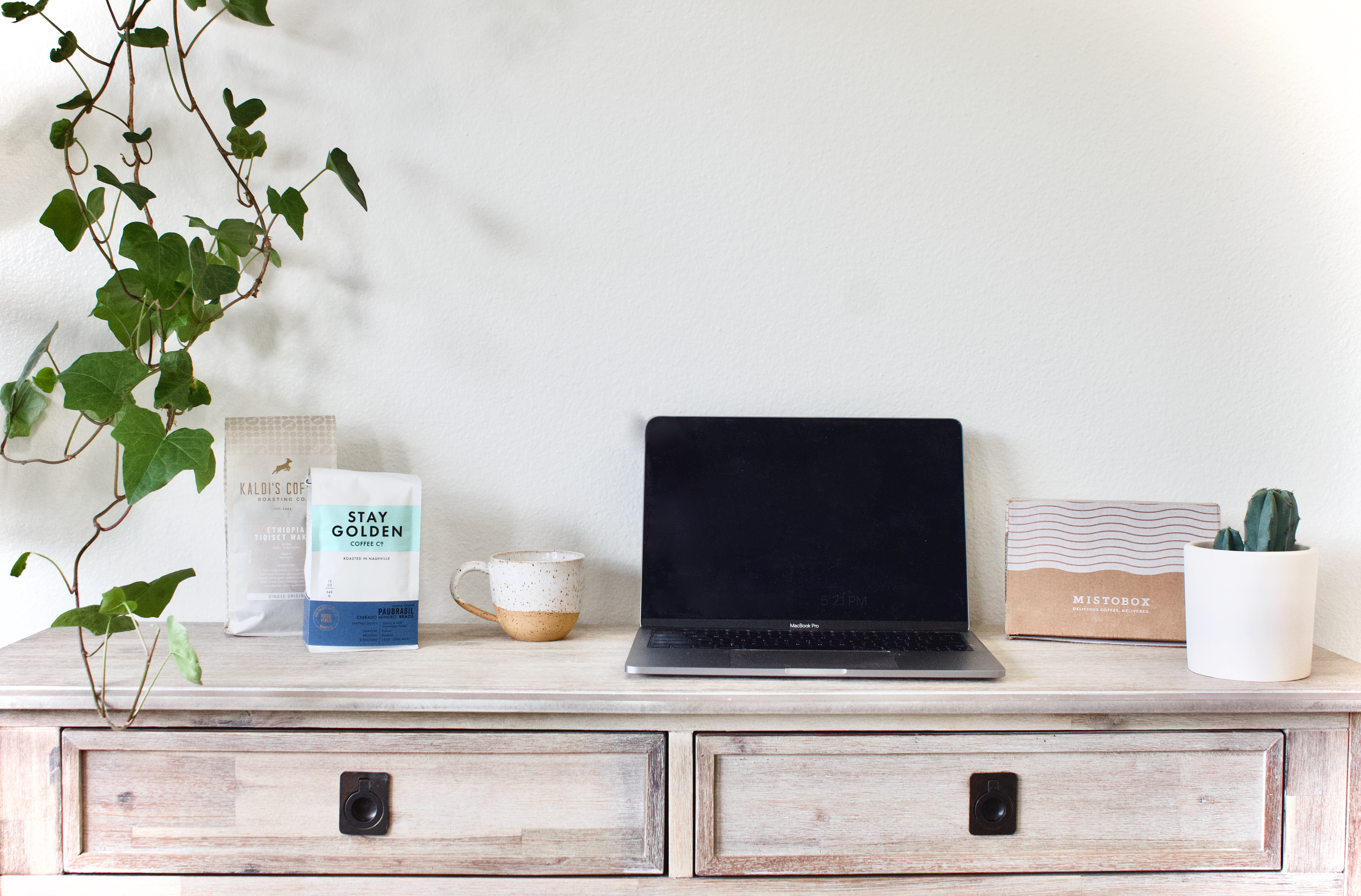 Laptop on home desk with coffee