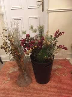 Glass vase with fake flowers and bucket with fake flowers