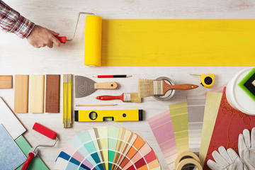 Painting decorating diy banner decorator holding roller wooden surface work tools swatches bottom copy space 53159637