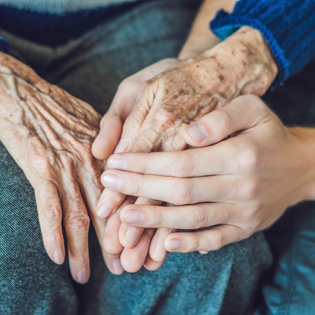 Serene and compassionate scene within an old age home, depicting elderly individuals engaging in activities and receiving care, representing the support and comfort provided through contributions to old age homes via the Karma platform