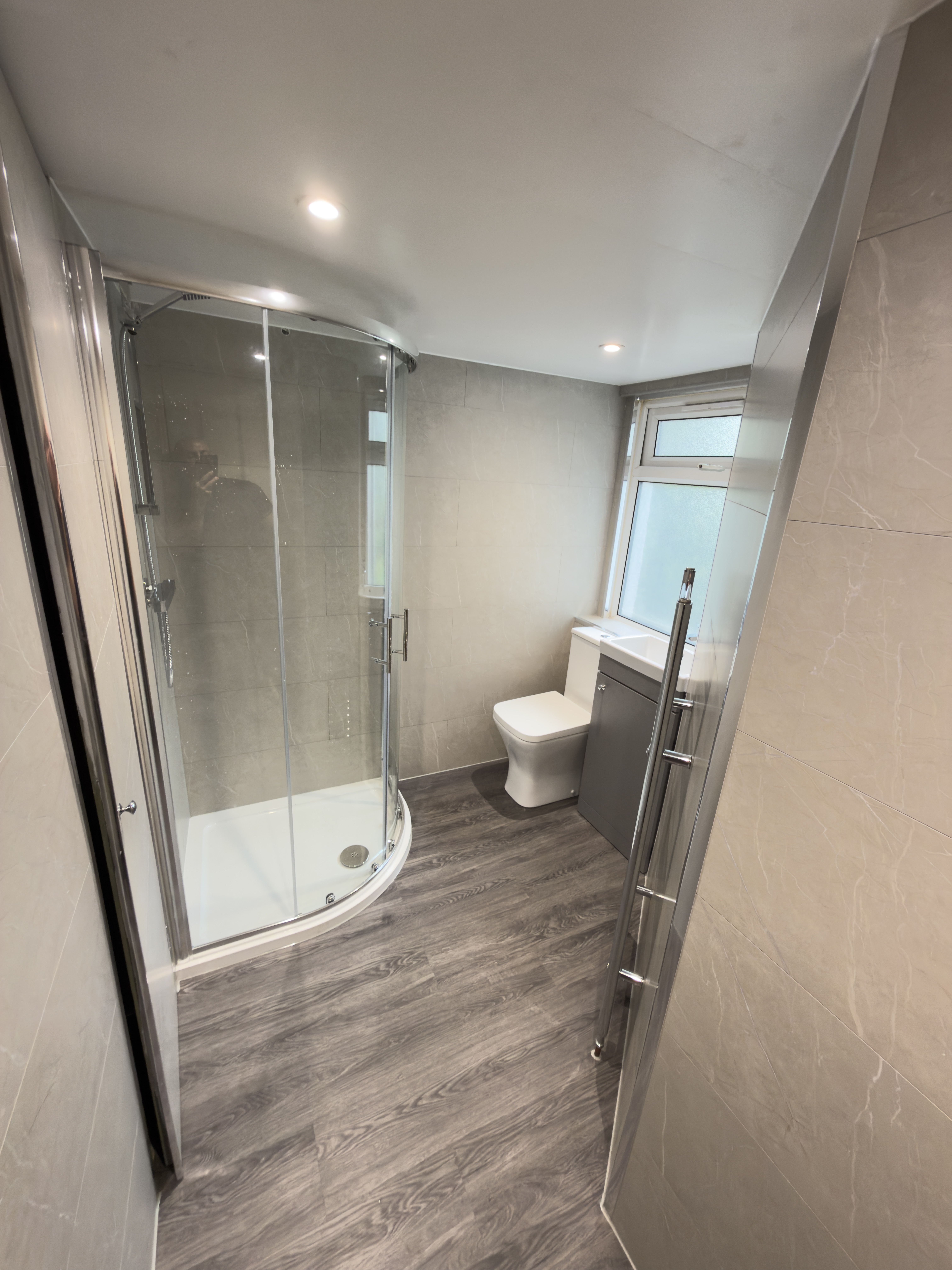 Completed modern shower room with a sleek design and efficient use of space.
