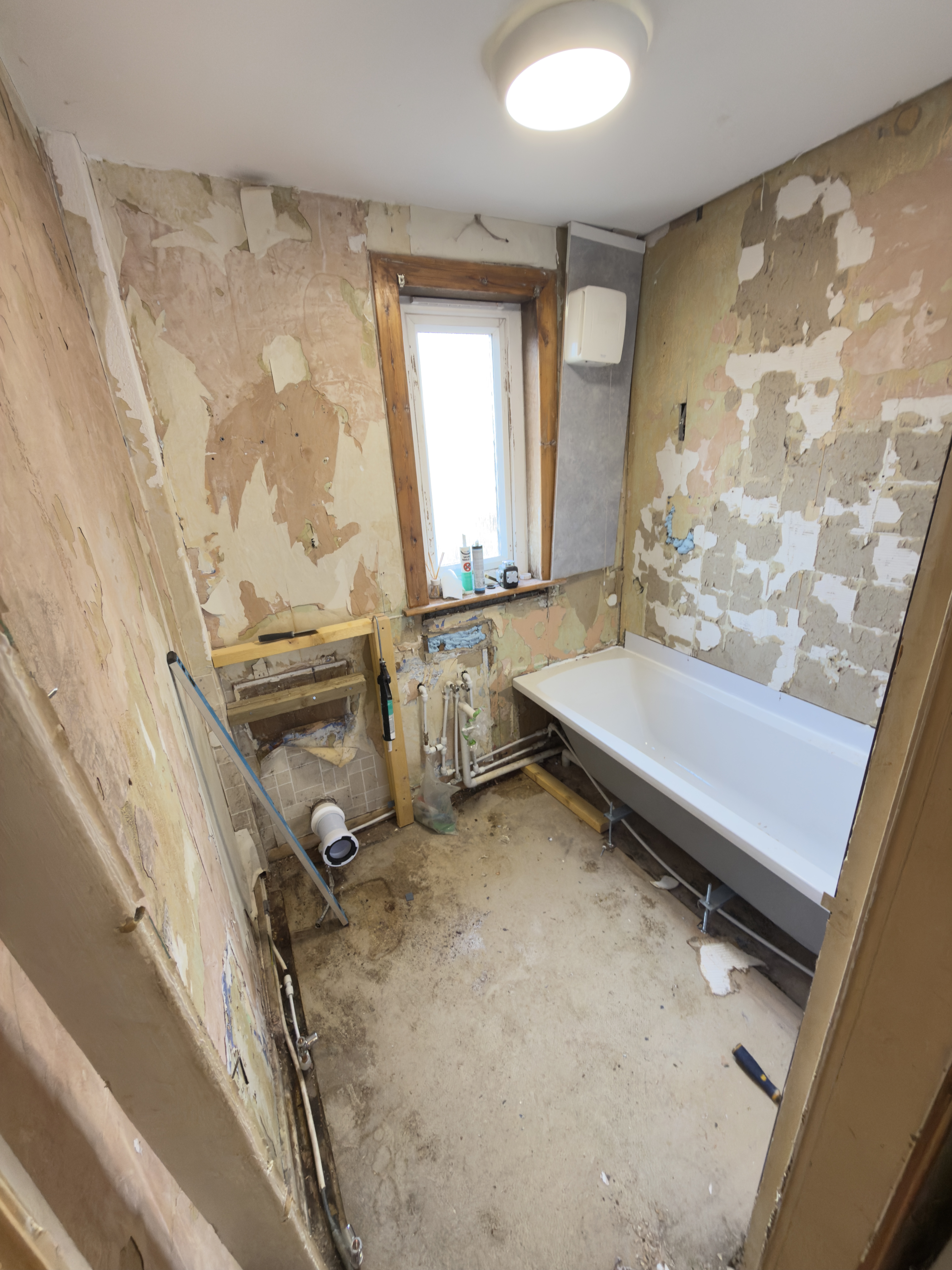 Original bathroom in disrepair with visible wear and outdated fixtures.
