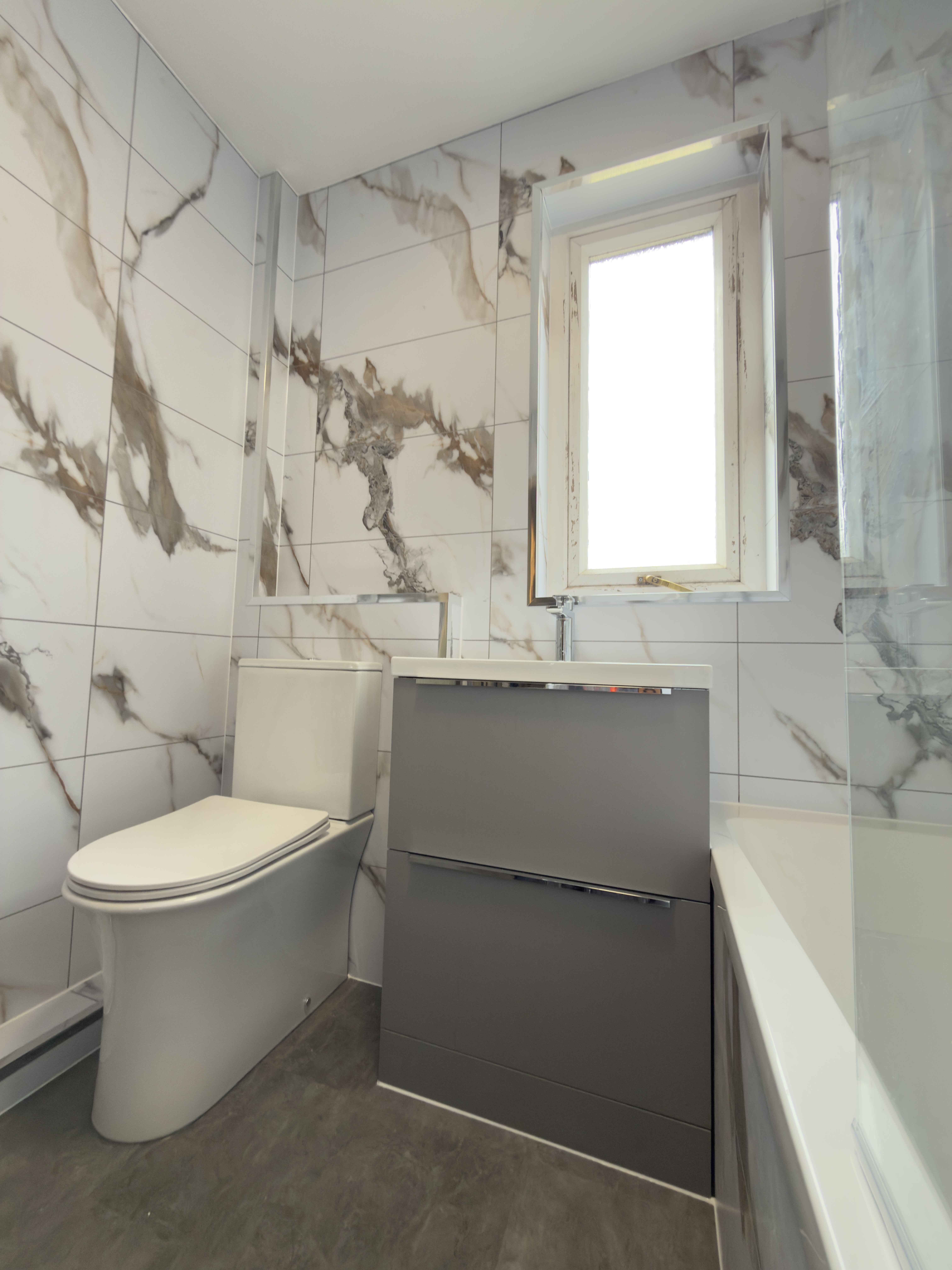 Grey vanity unit and close coupled WC showcasing the modern finish.