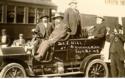 James J. Hill standing in automobile, by train and others at the Grant County Fair, Herman, Minnesota.