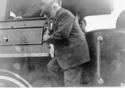 James J. Hill getting down from cab of William Crooks engine.