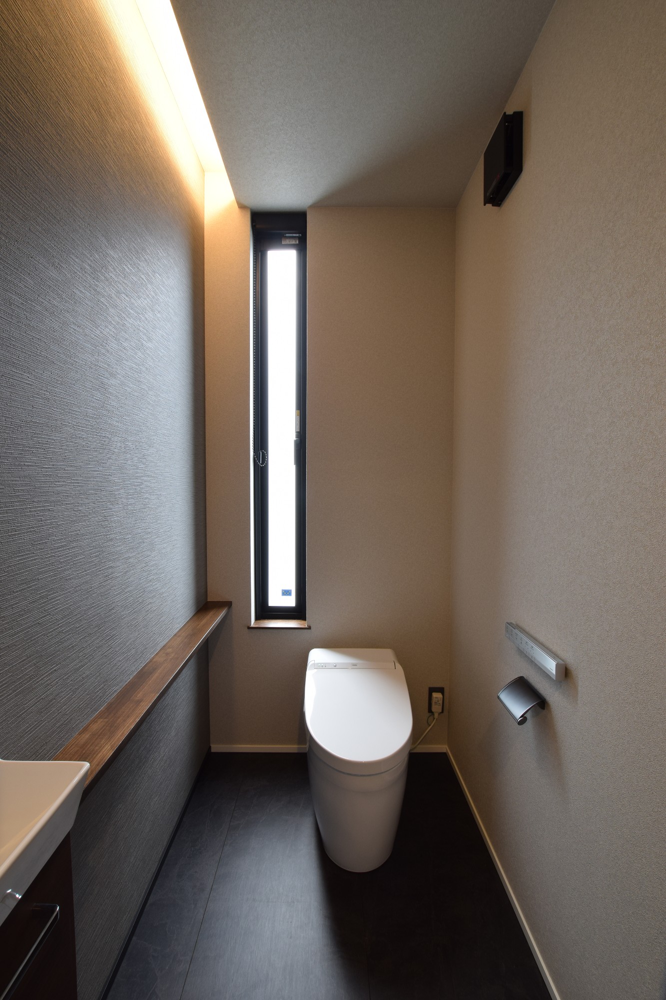 間接照明とモノトーンでまとめたシックなトイレ空間