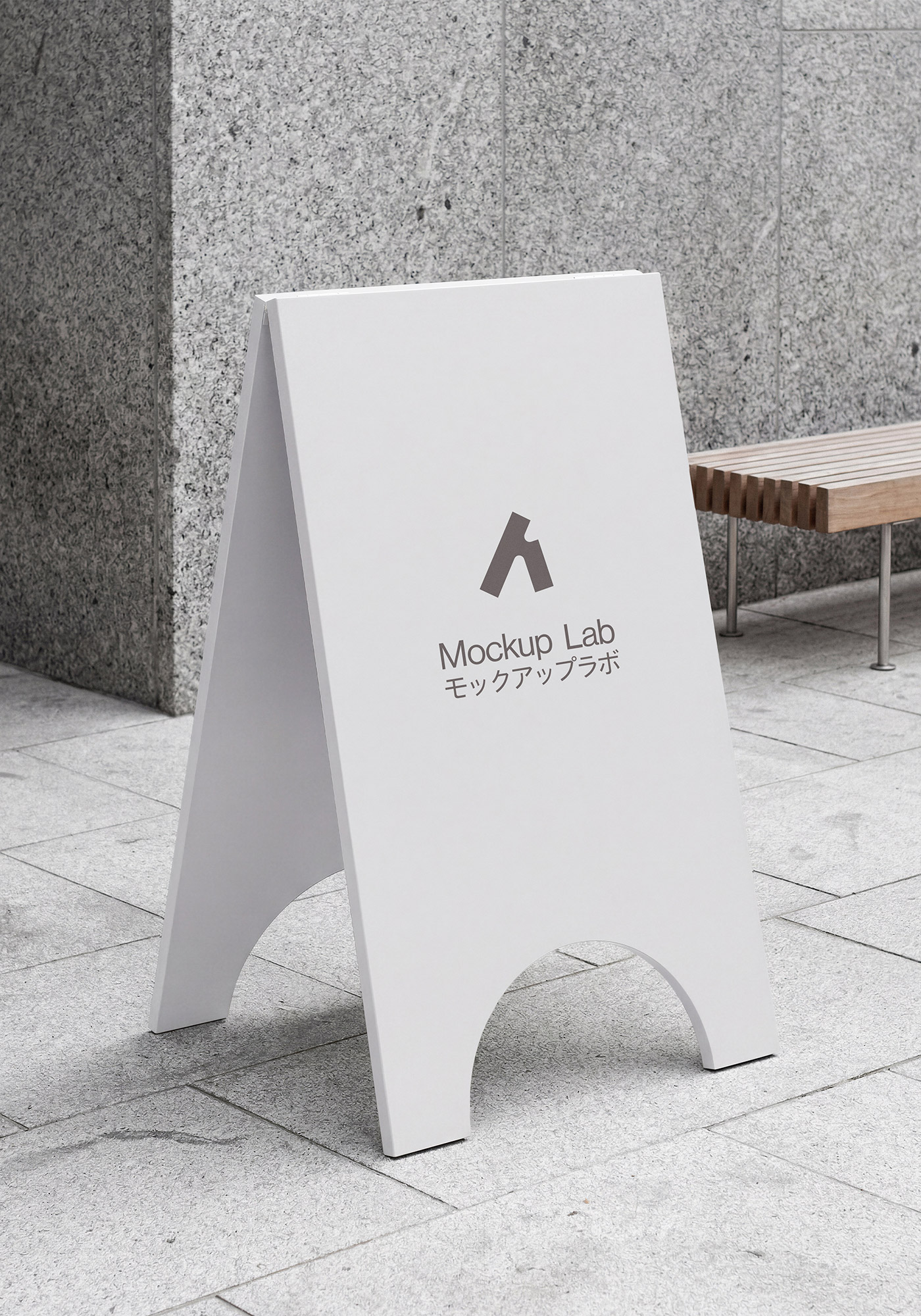 A-frame sign mockup positioned on a city sidewalk next to a building entrance.