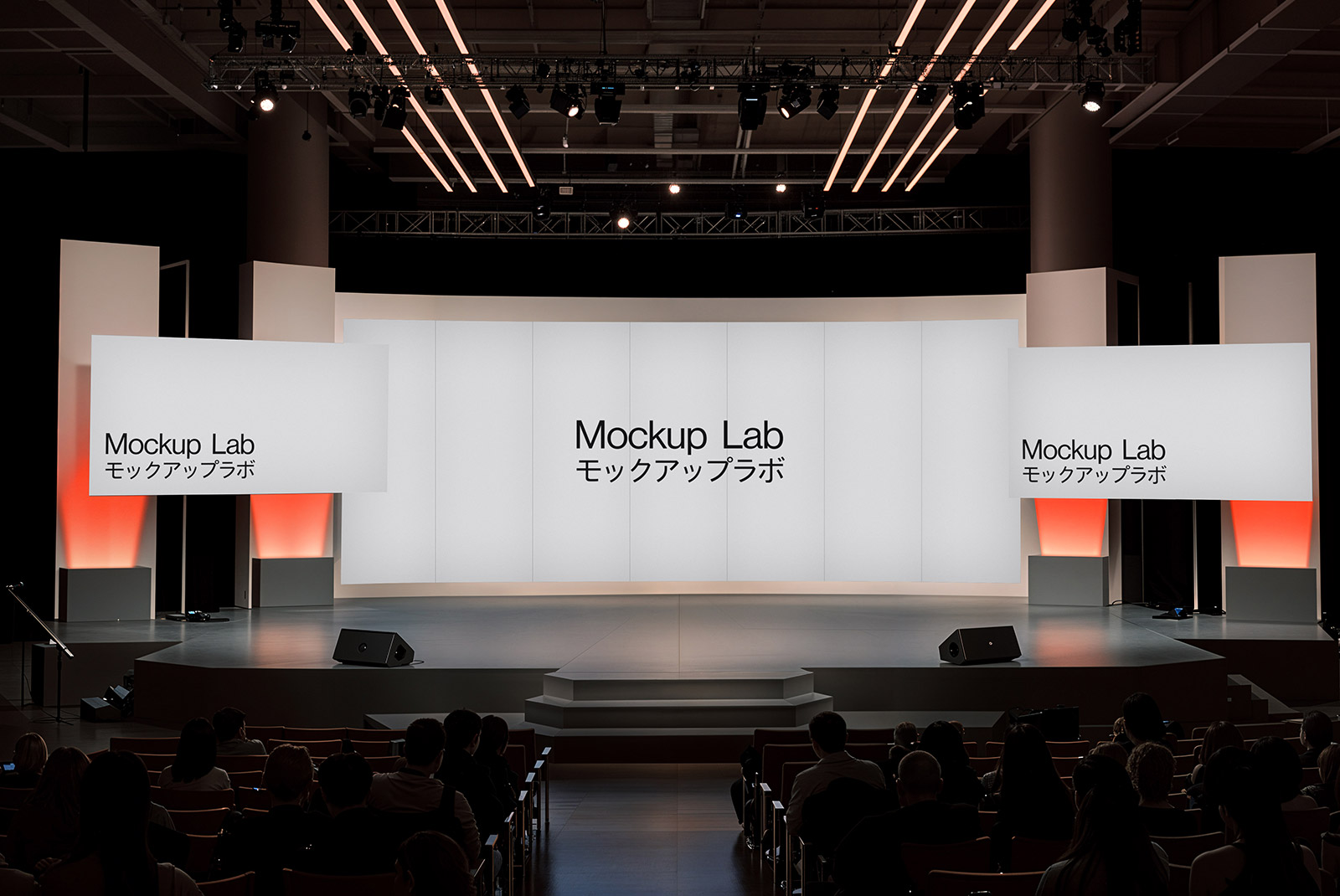 Front view of a large conference stage with a central screen and two side banners.