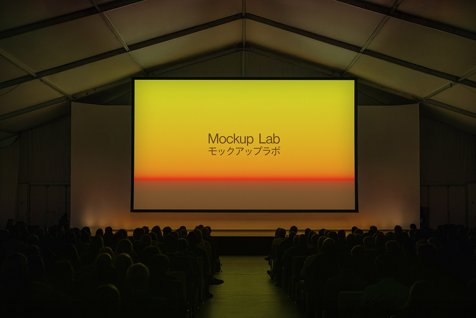 Frontal view of a large conference stage with multiple digital screens displaying designs.