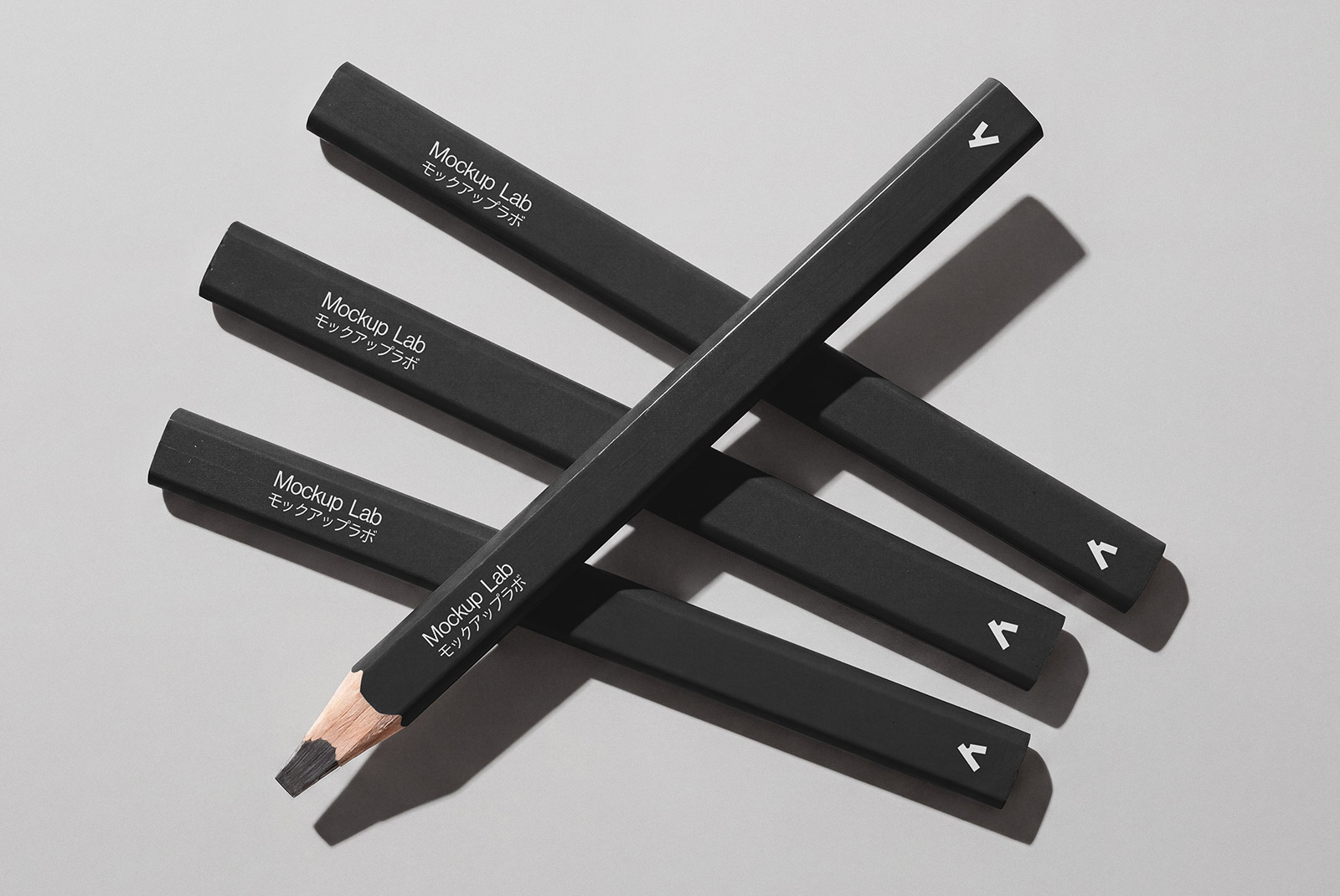 Overhead view of three pencils with custom branding on a clean background.